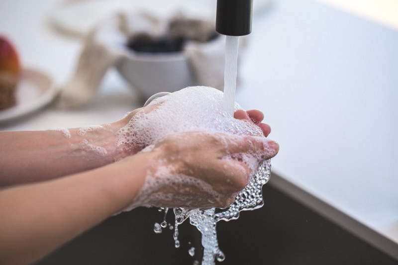 Washing your hands with soap as a prelude to towel or electric hand drying